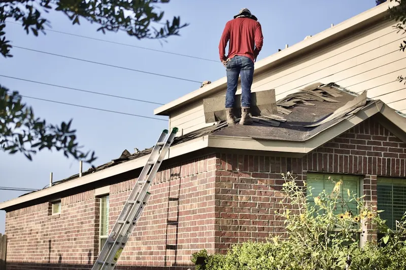Professional roofer working on a residential roof in Frankford